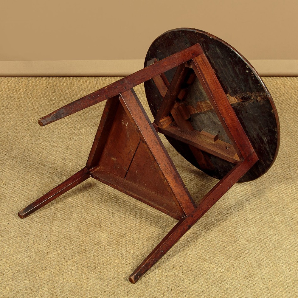 A mid-19th-century pollard oak cricket table with a round top, three splayed legs, and a triangular lower shelf. View VIII