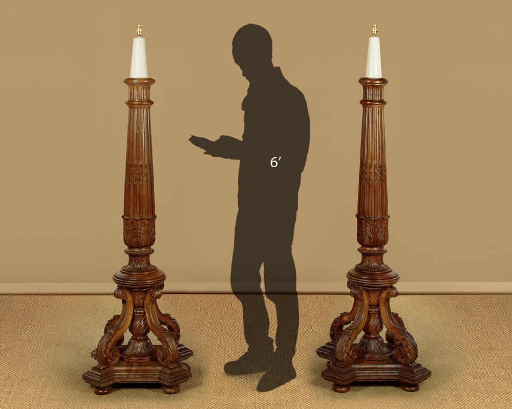 A pair of carved walnut standard lamps featuring fluted tapered shafts, acanthus scroll bases, and candle-style bulb sockets. View III