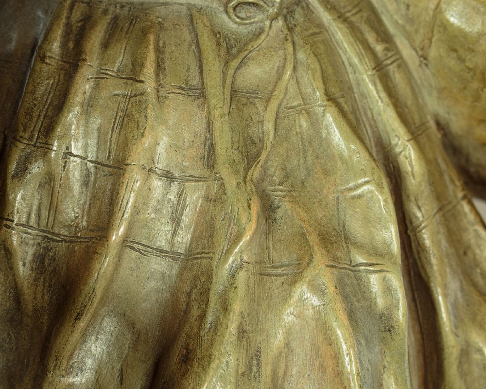 A patinated terracotta sculpture depicting a man and woman in traditional rural attire embracing while holding a woven basket. View IX