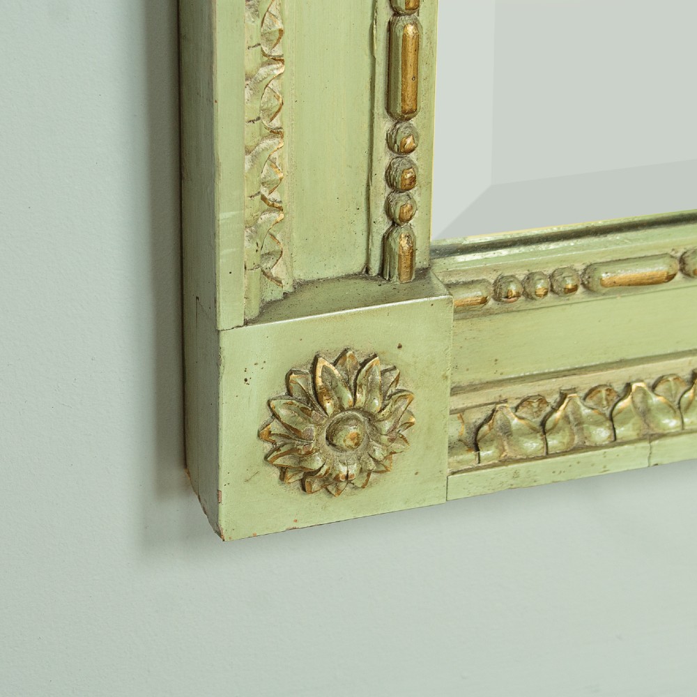 A large rectangular Edwardian mirror with an off-white painted and gilded wooden frame featuring rosette corner blocks and bevelled glass plate. View VII