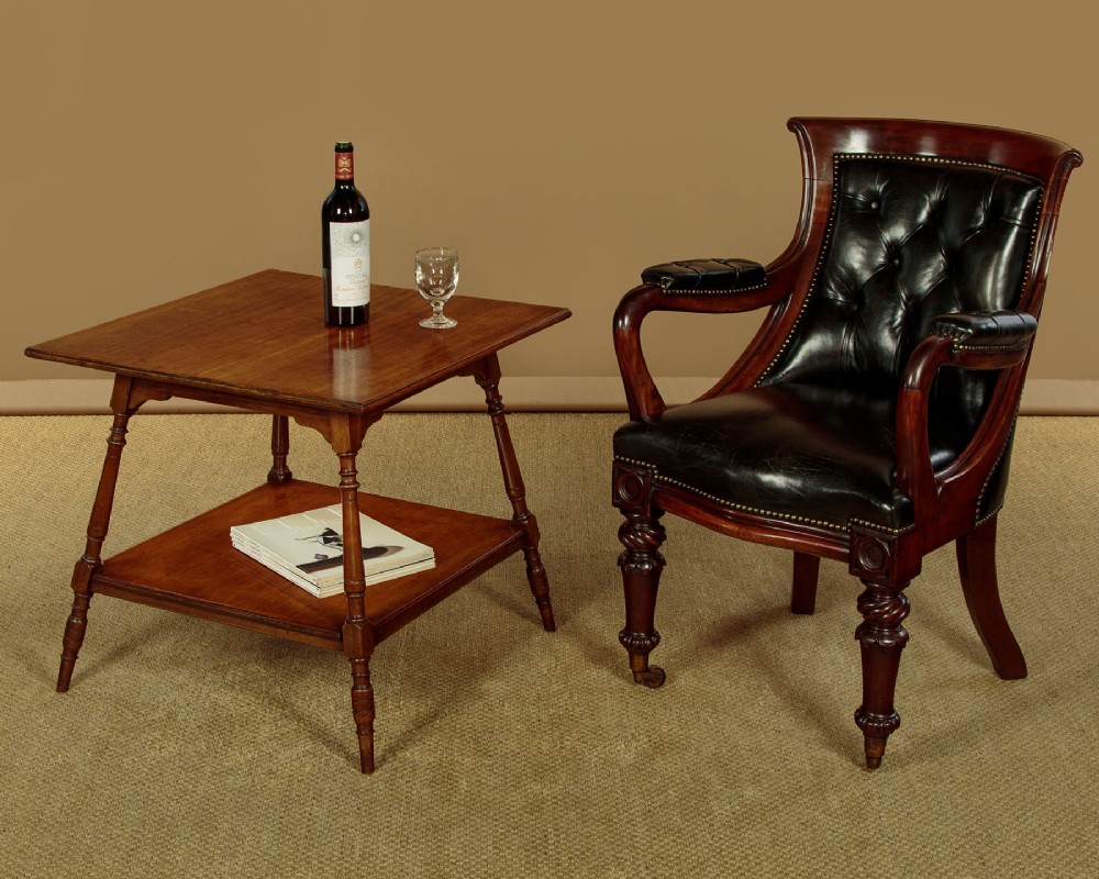 A square low Arts and Crafts style mahogany side table featuring turned splayed legs, a lower shelf, and decorative corner spandrels. View II