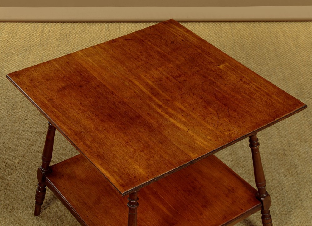 A square low Arts and Crafts style mahogany side table featuring turned splayed legs, a lower shelf, and decorative corner spandrels. View III