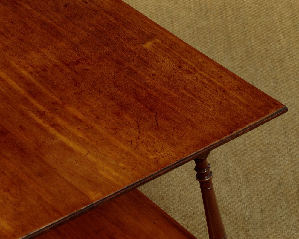 A square low Arts and Crafts style mahogany side table featuring turned splayed legs, a lower shelf, and decorative corner spandrels. View V