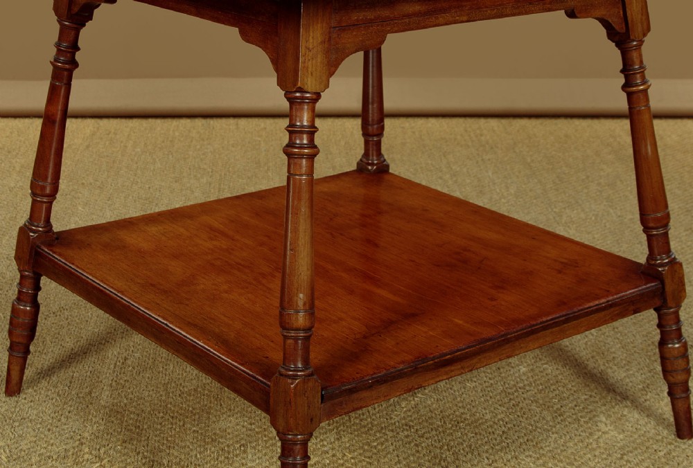 A square low Arts and Crafts style mahogany side table featuring turned splayed legs, a lower shelf, and decorative corner spandrels. View VI