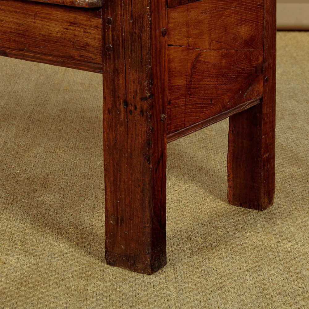 A small antique warm brown oak hall bench featuring a slatted open backrest, straight armrests, and a solid plank seat. View VII