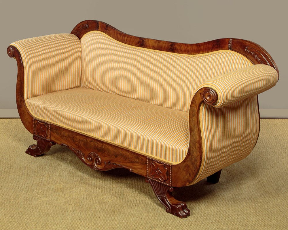 A Regency mahogany scroll end couch featuring swept arms, carved anthemion accents, and yellow striped fabric upholstery. View II