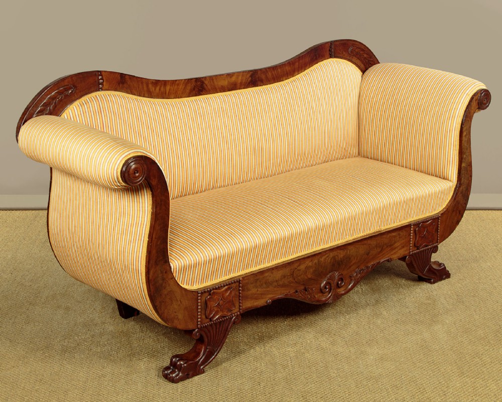 A Regency mahogany scroll end couch featuring swept arms, carved anthemion accents, and yellow striped fabric upholstery. View III