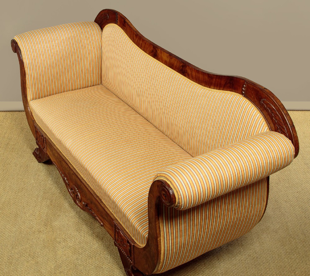 A Regency mahogany scroll end couch featuring swept arms, carved anthemion accents, and yellow striped fabric upholstery. View IV