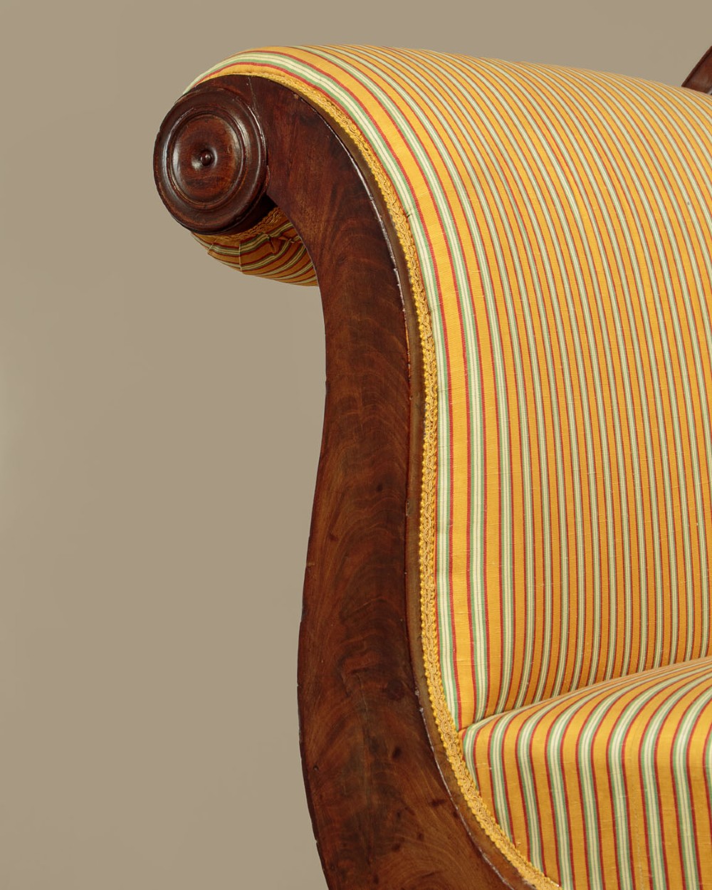 A Regency mahogany scroll end couch featuring swept arms, carved anthemion accents, and yellow striped fabric upholstery. View VI