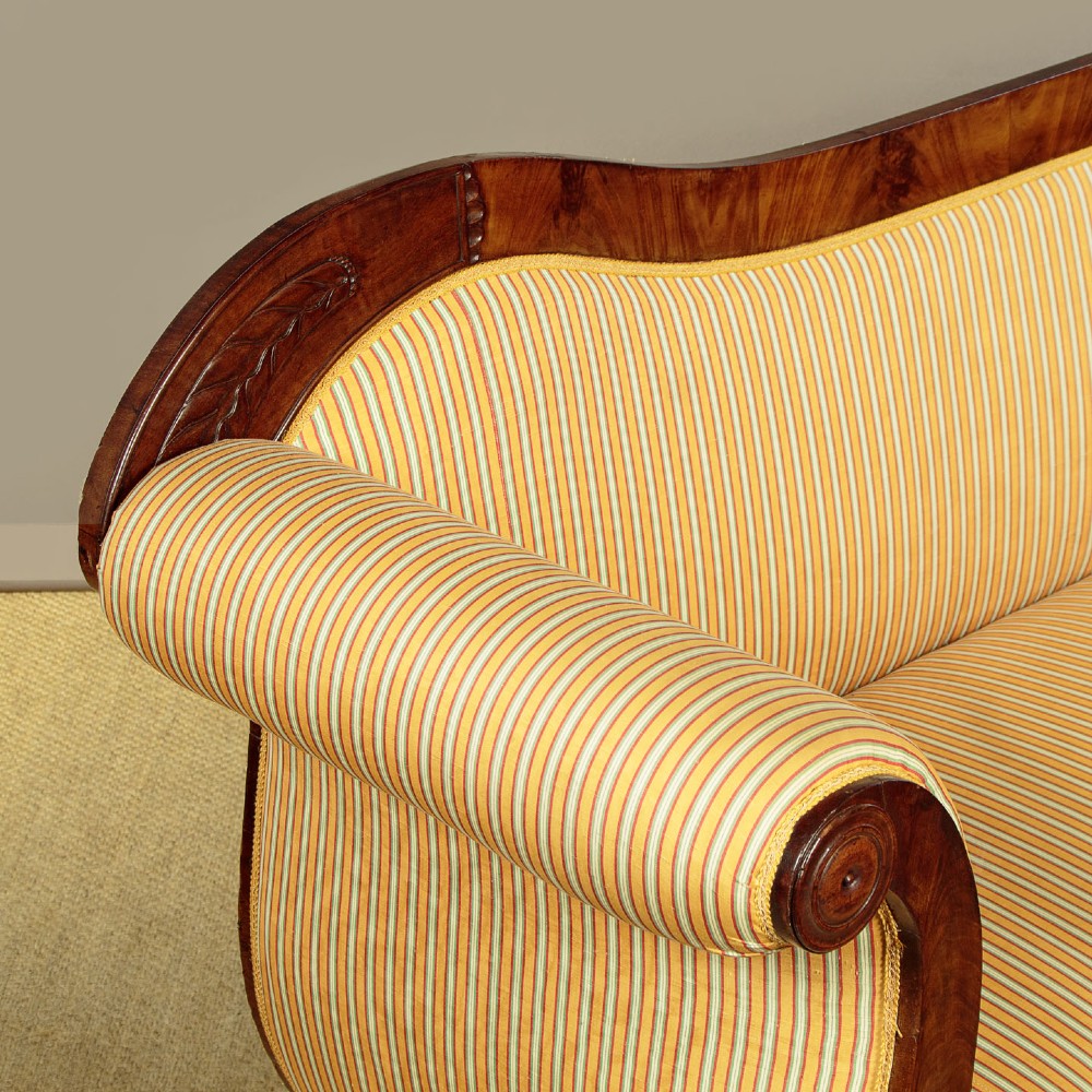 A Regency mahogany scroll end couch featuring swept arms, carved anthemion accents, and yellow striped fabric upholstery. View VII