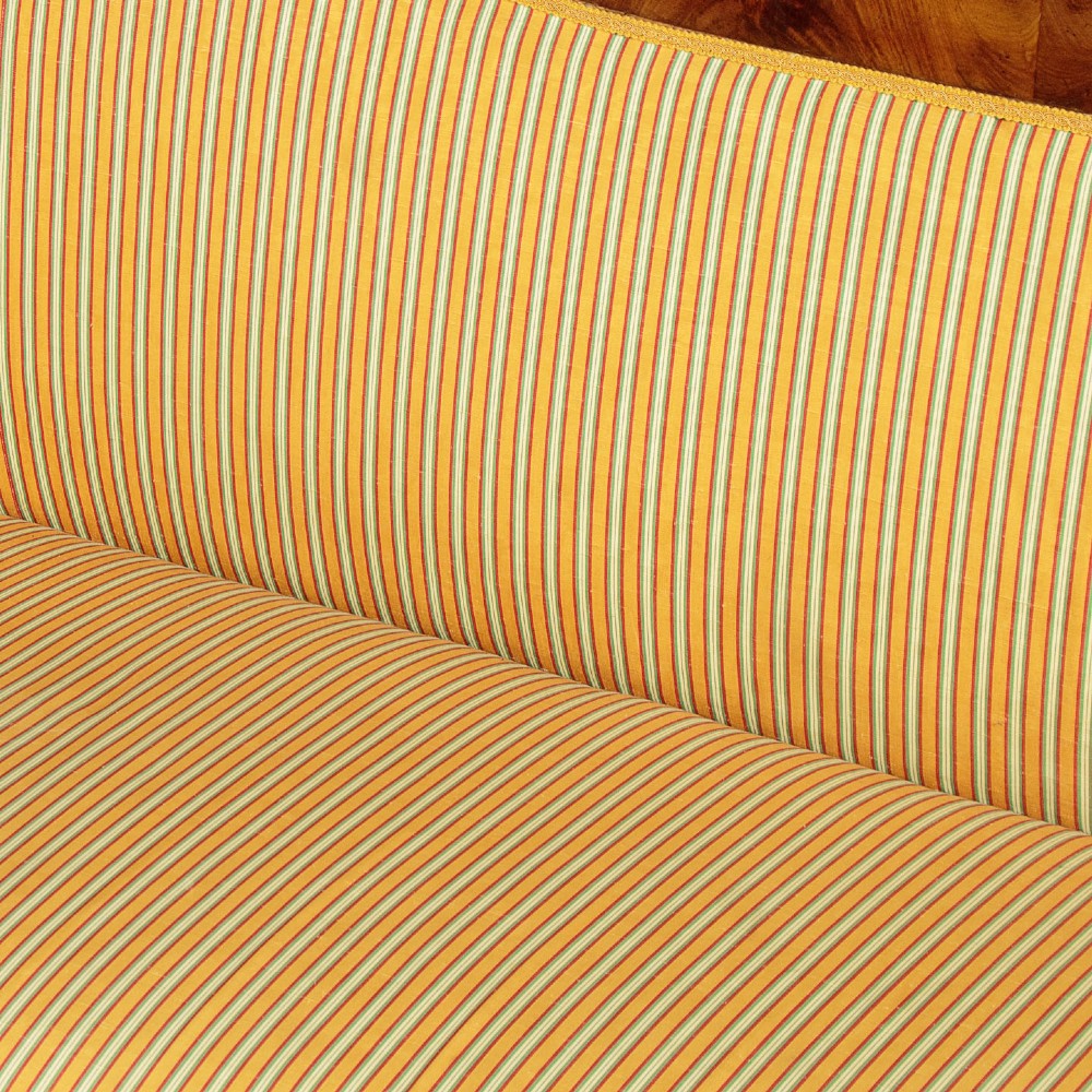 A Regency mahogany scroll end couch featuring swept arms, carved anthemion accents, and yellow striped fabric upholstery. View VIII