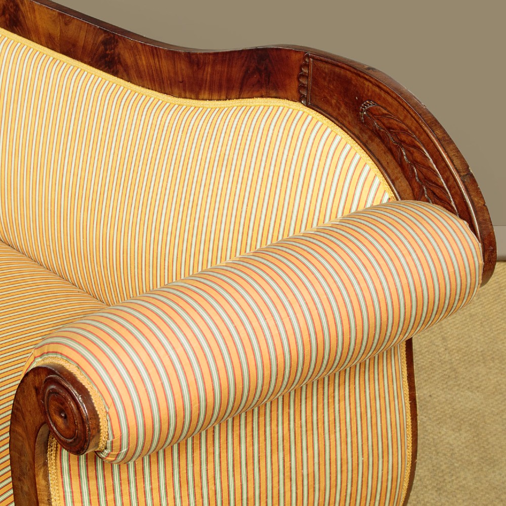 A Regency mahogany scroll end couch featuring swept arms, carved anthemion accents, and yellow striped fabric upholstery. View IX