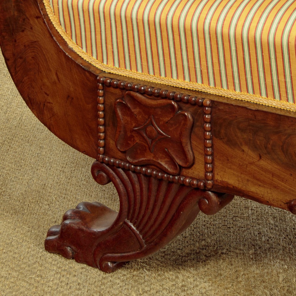 A Regency mahogany scroll end couch featuring swept arms, carved anthemion accents, and yellow striped fabric upholstery. View XI