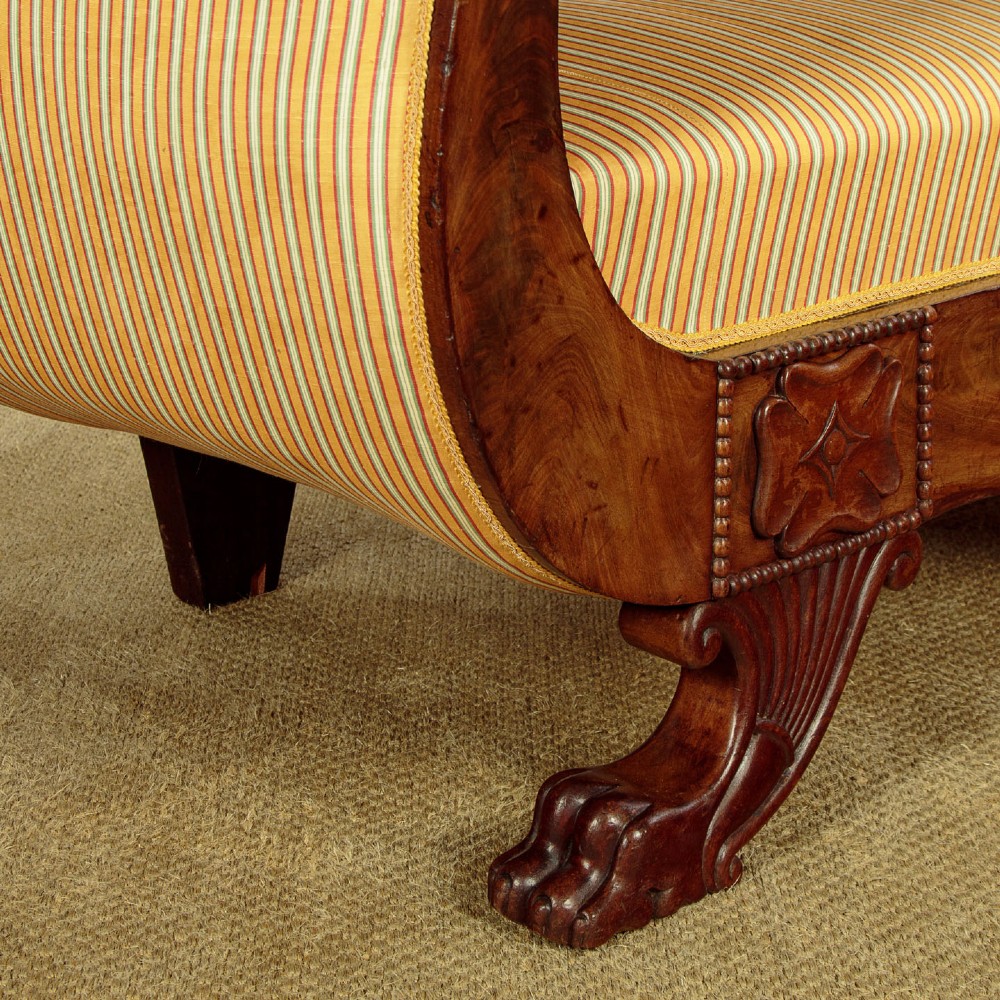 A Regency mahogany scroll end couch featuring swept arms, carved anthemion accents, and yellow striped fabric upholstery. View XII