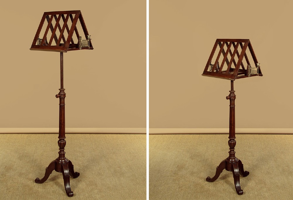 An antique dark mahogany duet music stand with a double-sided slatted rack, twin adjustable brass candle sconces, and a tripod base. View III