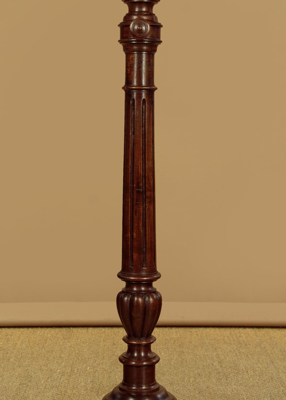An antique dark mahogany duet music stand with a double-sided slatted rack, twin adjustable brass candle sconces, and a tripod base. View VIII