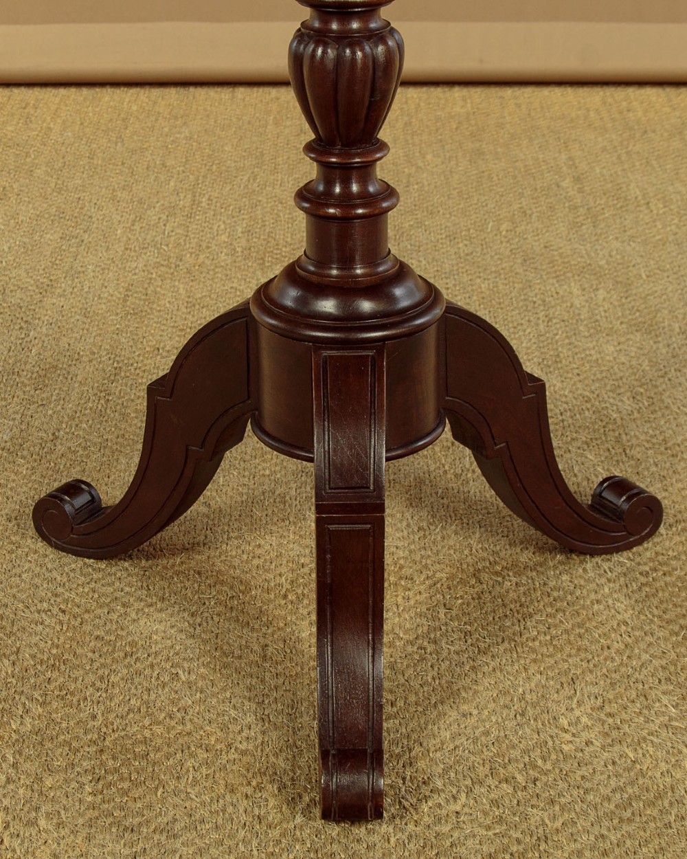 An antique dark mahogany duet music stand with a double-sided slatted rack, twin adjustable brass candle sconces, and a tripod base. View IX
