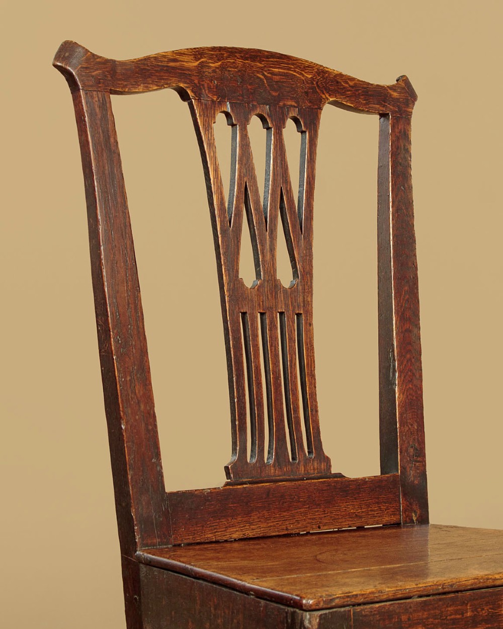 A set of six dark oak Country Chippendale dining chairs featuring pierced splat backs, solid seats, and square legs connected by stretchers. View V