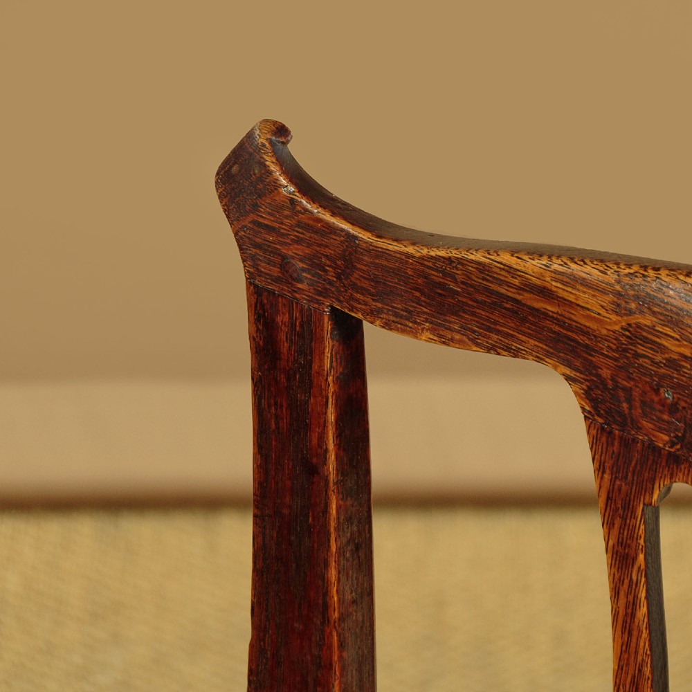 A set of six dark oak Country Chippendale dining chairs featuring pierced splat backs, solid seats, and square legs connected by stretchers. View VII
