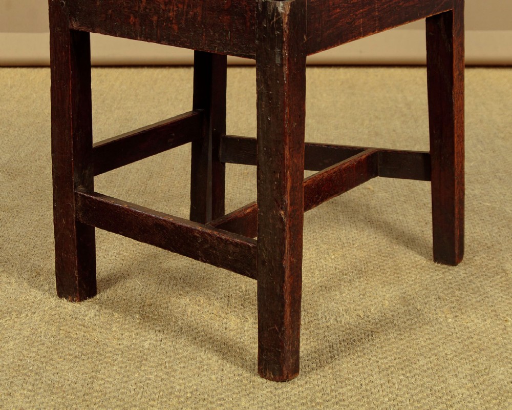 A set of six dark oak Country Chippendale dining chairs featuring pierced splat backs, solid seats, and square legs connected by stretchers. View X