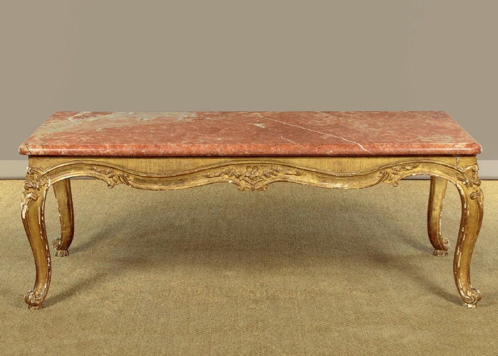 A low rectangular coffee table featuring a pink and red veined marble top supported by a carved giltwood frame with cabriole legs. View III