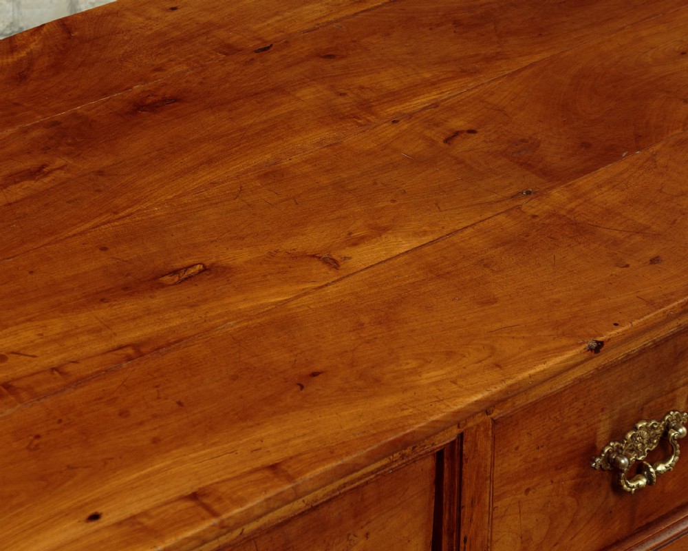 A mid-19th-century French cherry wood kitchen work table featuring three front drawers with brass handles and tapered square legs. View VIII
