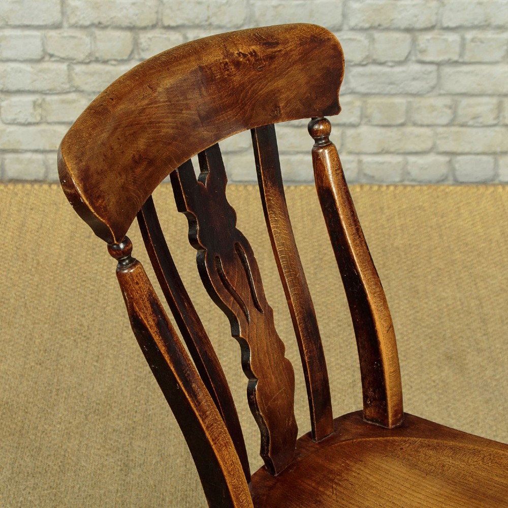 A set of four late 19th-century dark oak dining chairs featuring shaped back rails, pierced splats, contoured wooden seats, and turned legs with stretchers. View VII