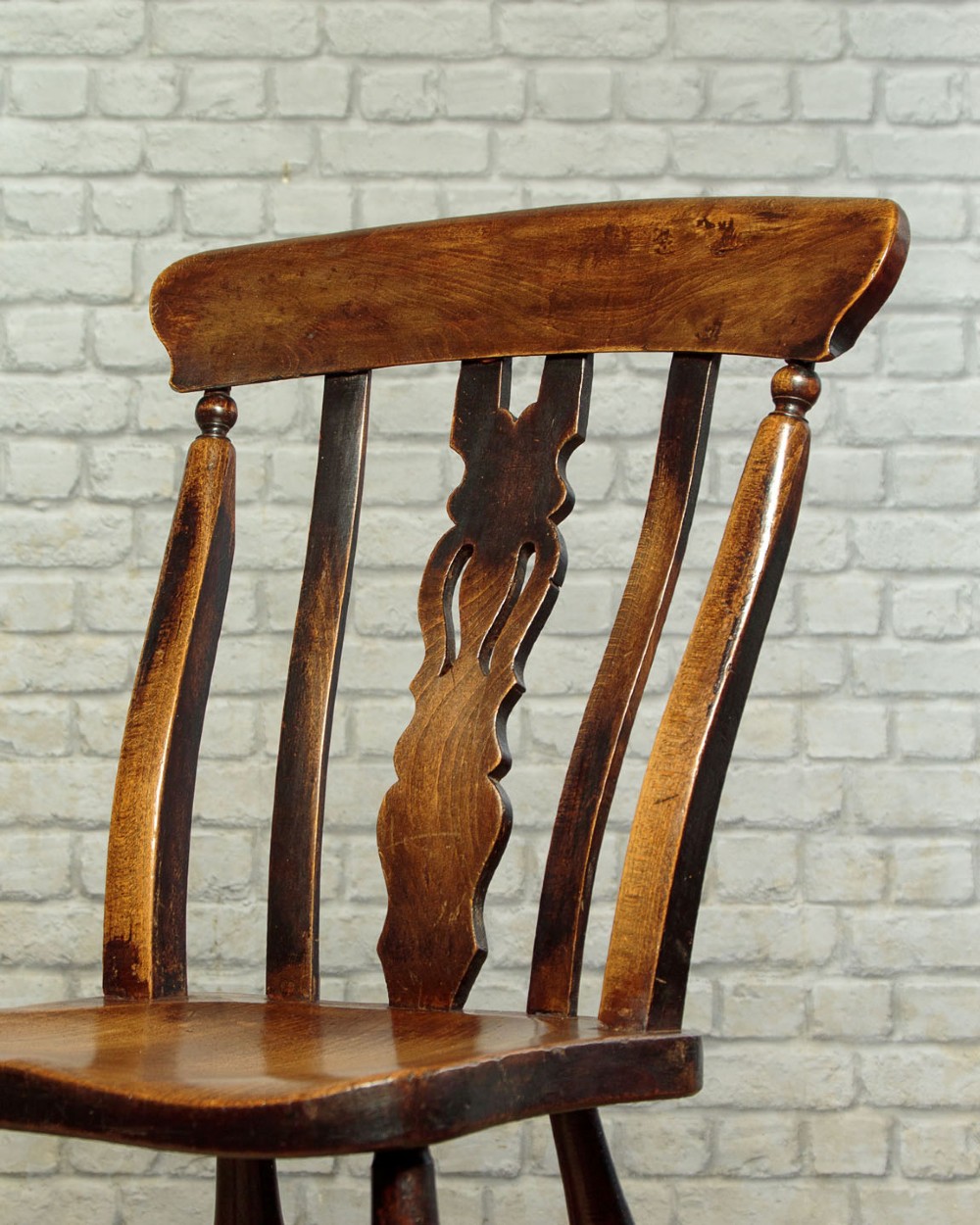 A set of four late 19th-century dark oak dining chairs featuring shaped back rails, pierced splats, contoured wooden seats, and turned legs with stretchers. View VIII