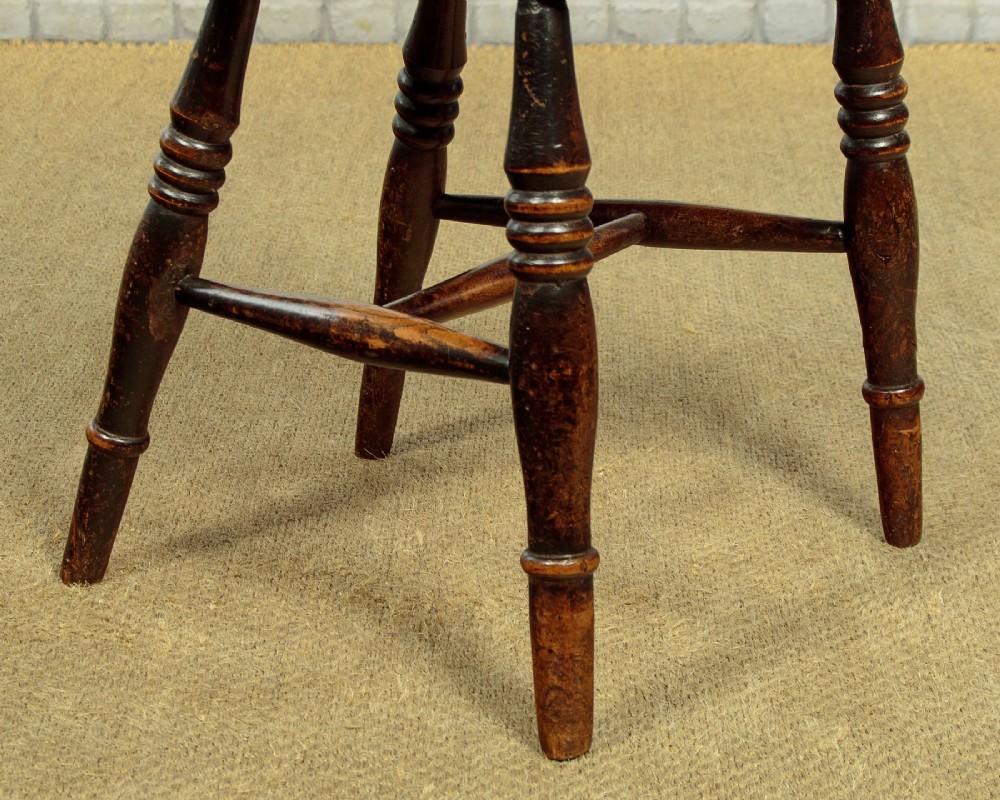 A set of four late 19th-century dark oak dining chairs featuring shaped back rails, pierced splats, contoured wooden seats, and turned legs with stretchers. View XI