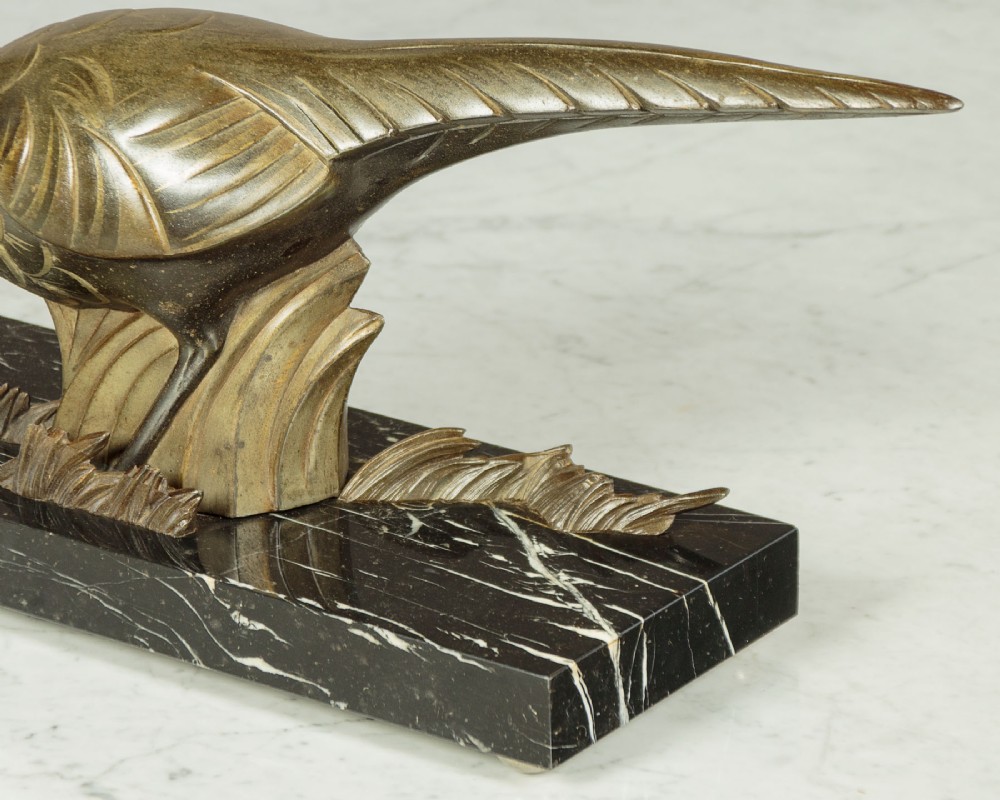 An Art Deco patinated metal sculpture featuring two stylised pheasants mounted on a rectangular black marble base with white veining. View VII