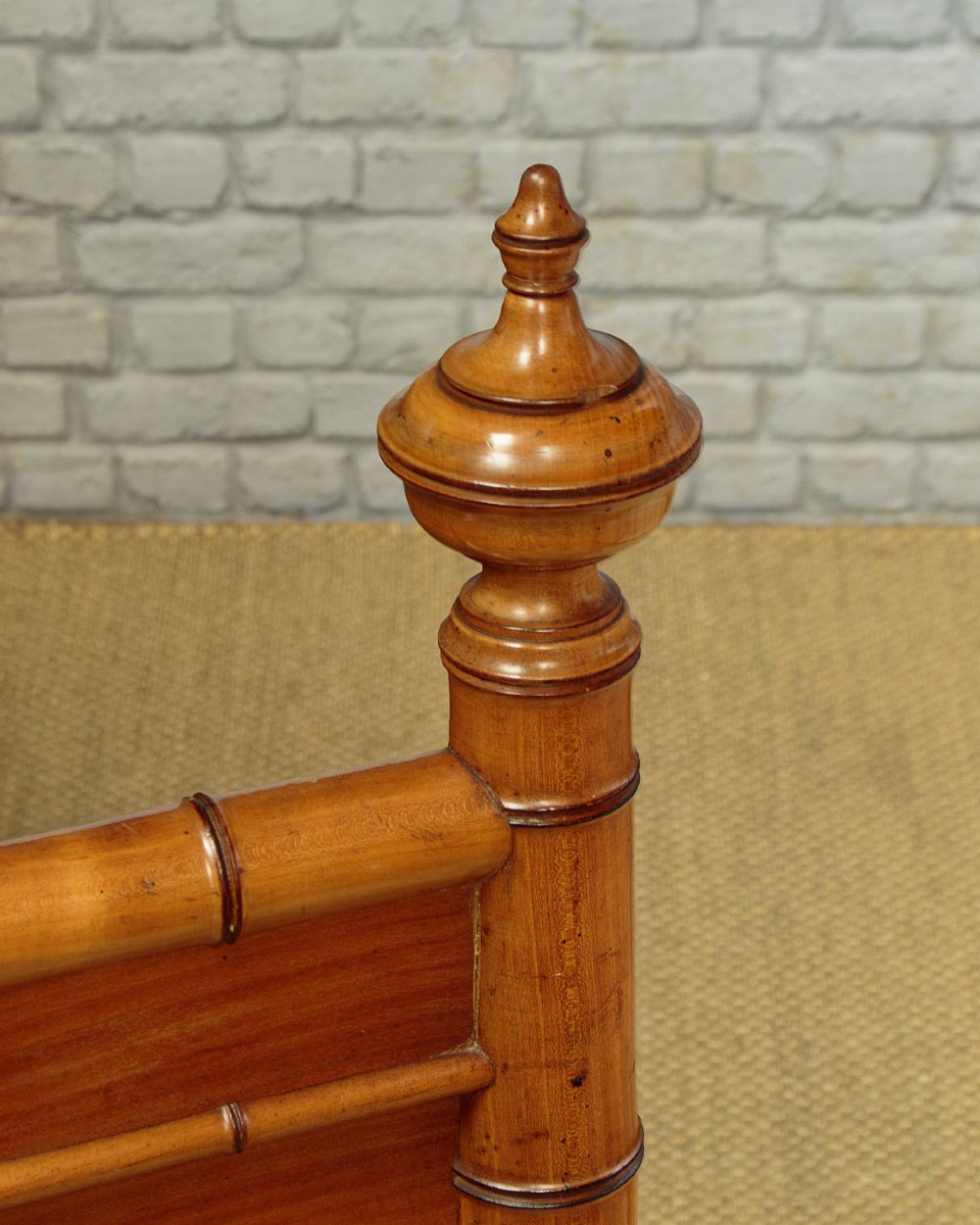 A late 19th-century faux bamboo double bed frame in warm brown wood, featuring turned bamboo-effect posts, finials, and panelled headboard and footboard. View VI