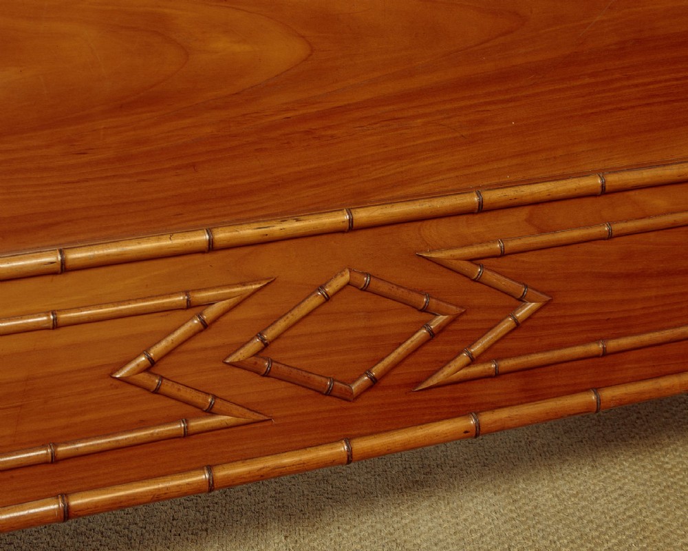 A late 19th-century faux bamboo double bed frame in warm brown wood, featuring turned bamboo-effect posts, finials, and panelled headboard and footboard. View VII