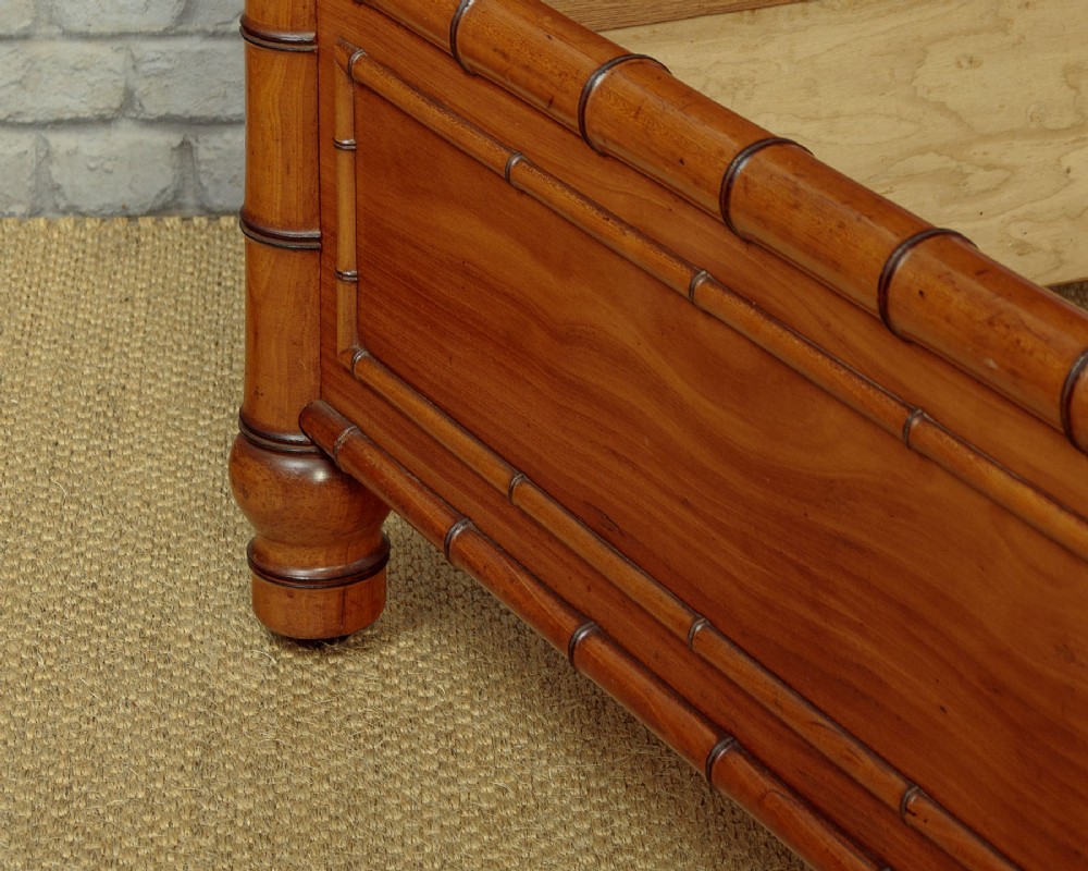 A late 19th-century faux bamboo double bed frame in warm brown wood, featuring turned bamboo-effect posts, finials, and panelled headboard and footboard. View VIII