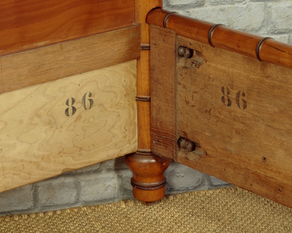 A late 19th-century faux bamboo double bed frame in warm brown wood, featuring turned bamboo-effect posts, finials, and panelled headboard and footboard. View IX