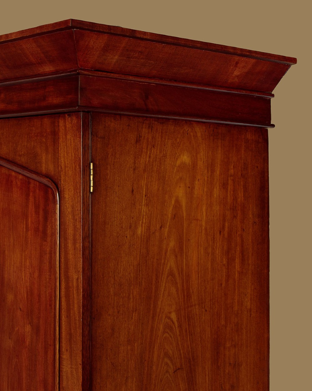 A nineteenth-century mahogany linen press featuring flame mahogany panel doors opening to reveal timber trays above a base of four drawers with turned wooden knobs. View VI