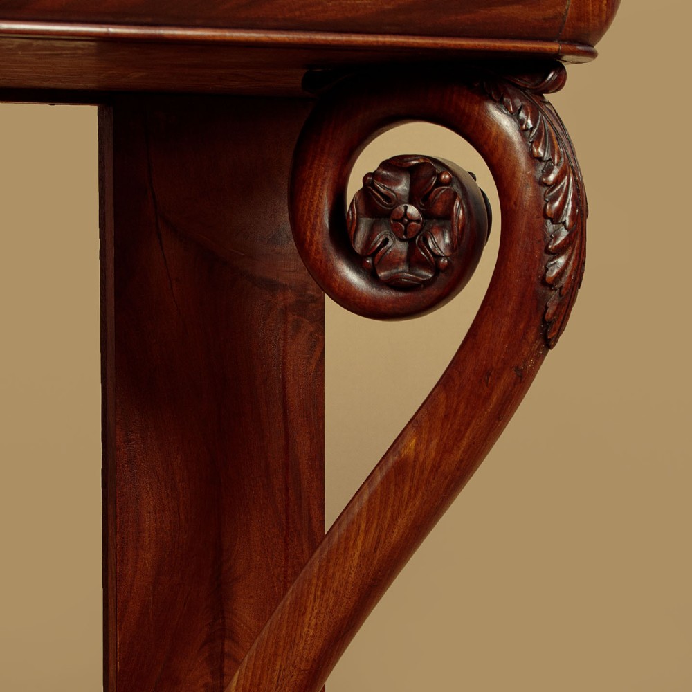 A 19th-century Victorian mahogany console table featuring carved S-scroll front supports and a concave plinth base. View XI
