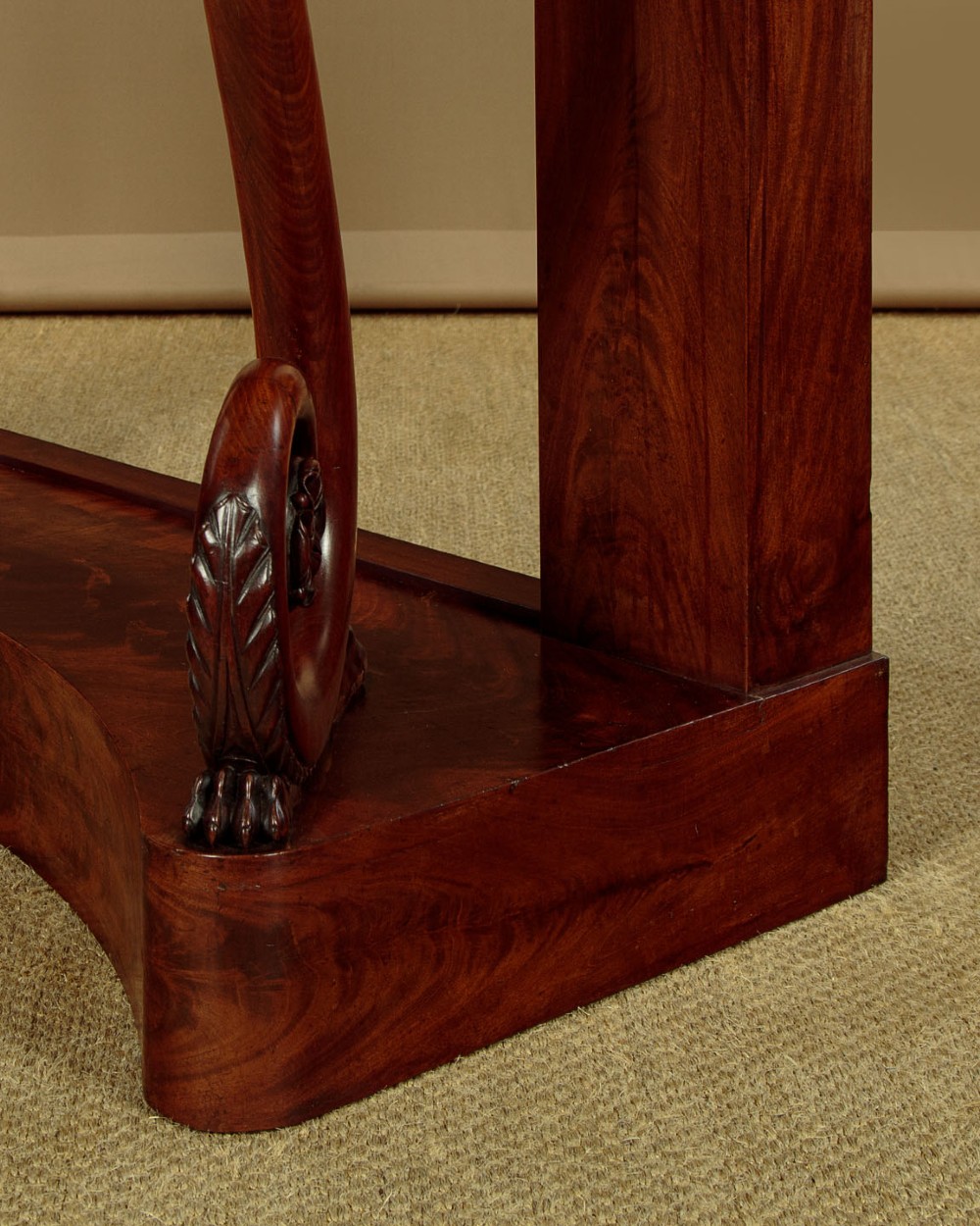 A 19th-century Victorian mahogany console table featuring carved S-scroll front supports and a concave plinth base. View XIII