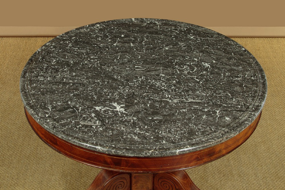A 19th-century circular gueridon centre table featuring a dark grey marble top, warm walnut veneer with string inlay, a bulbous pedestal, and carved paw feet. View III