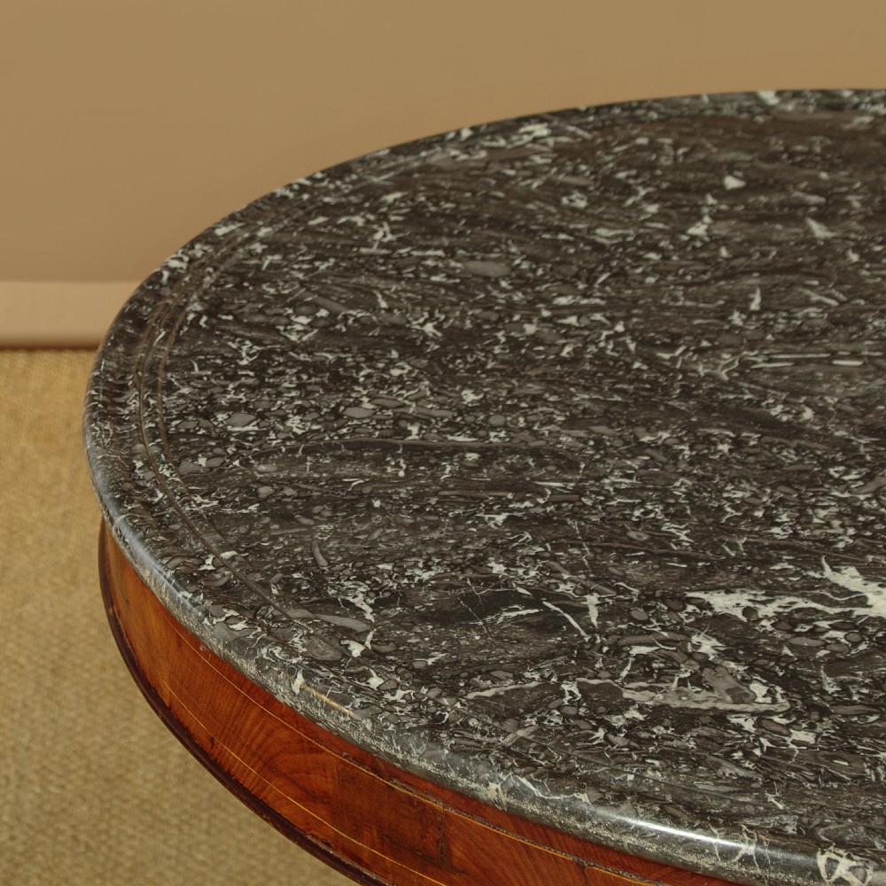 A 19th-century circular gueridon centre table featuring a dark grey marble top, warm walnut veneer with string inlay, a bulbous pedestal, and carved paw feet. View IV
