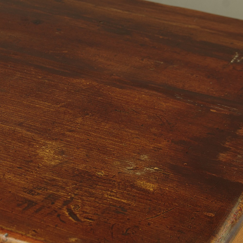 An antique 19th-century painted pine dresser base with central drawers, two side cupboard doors, red painted accent panels, and brass handles. View V