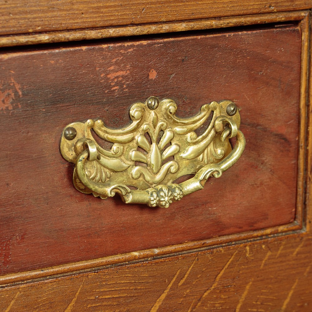 An antique 19th-century painted pine dresser base with central drawers, two side cupboard doors, red painted accent panels, and brass handles. View VII