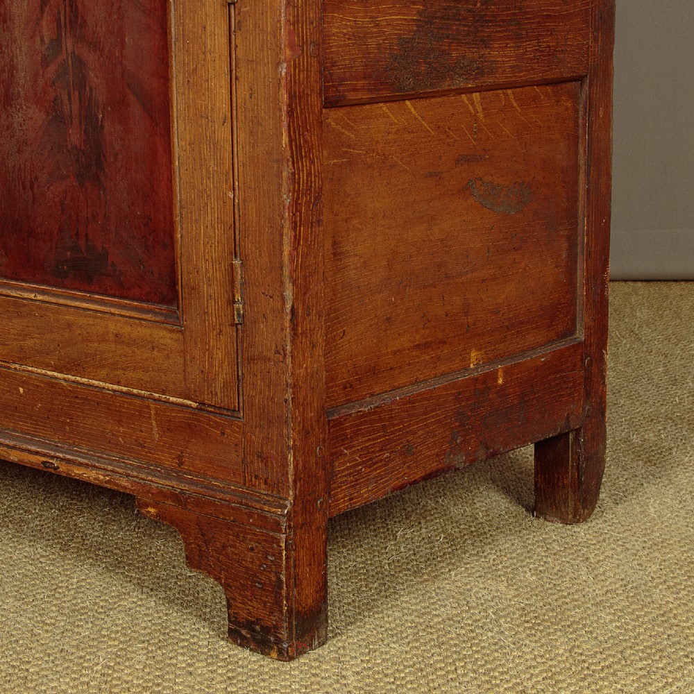 An antique 19th-century painted pine dresser base with central drawers, two side cupboard doors, red painted accent panels, and brass handles. View XII