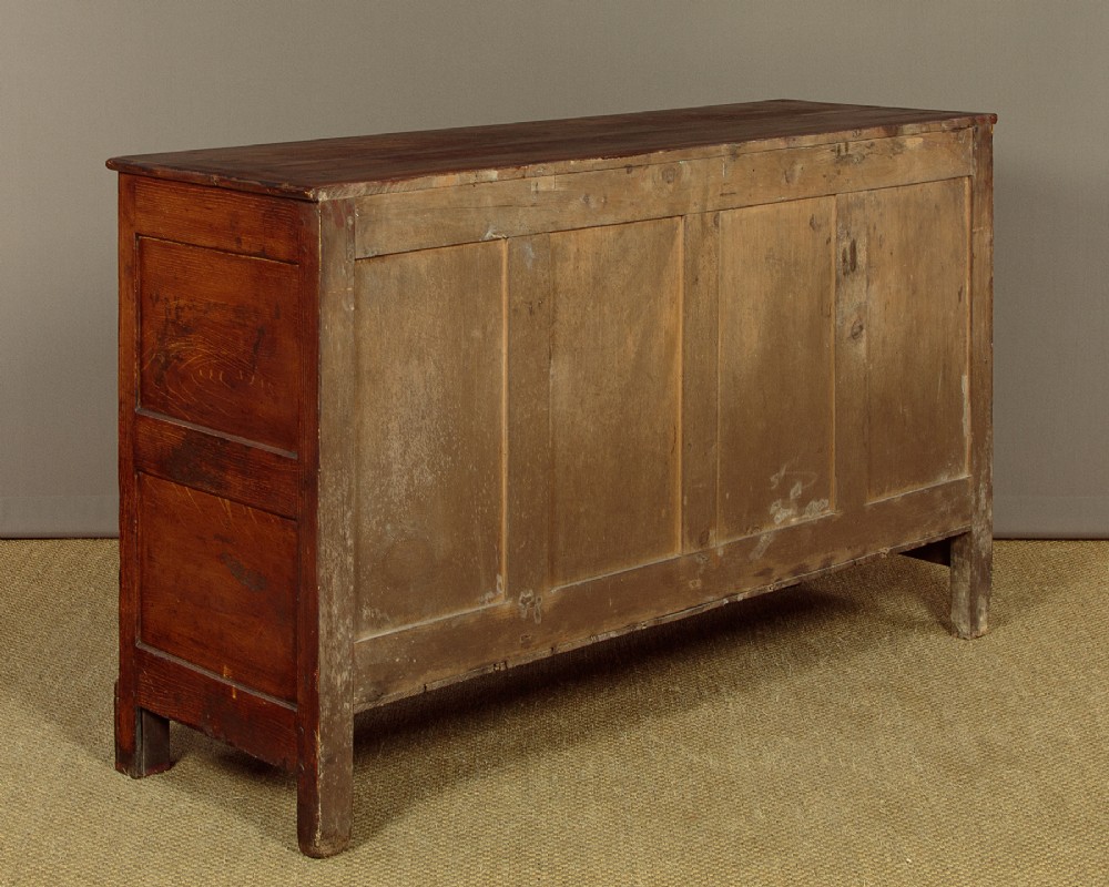 An antique 19th-century painted pine dresser base with central drawers, two side cupboard doors, red painted accent panels, and brass handles. View XIII