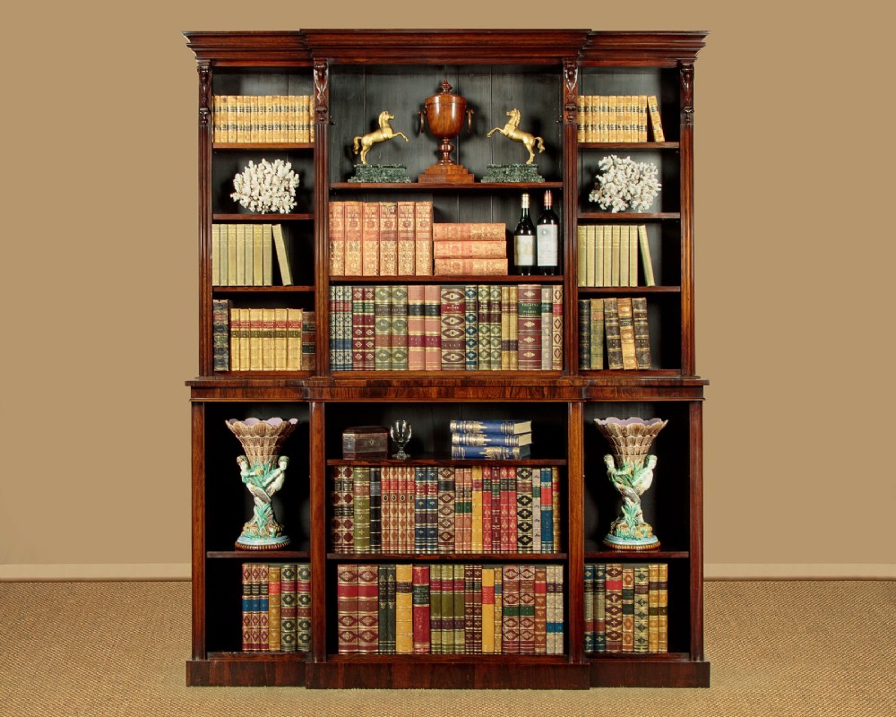 A mid-19th century dark rosewood open breakfront bookcase featuring a central projecting section flanked by narrower side shelves. View II