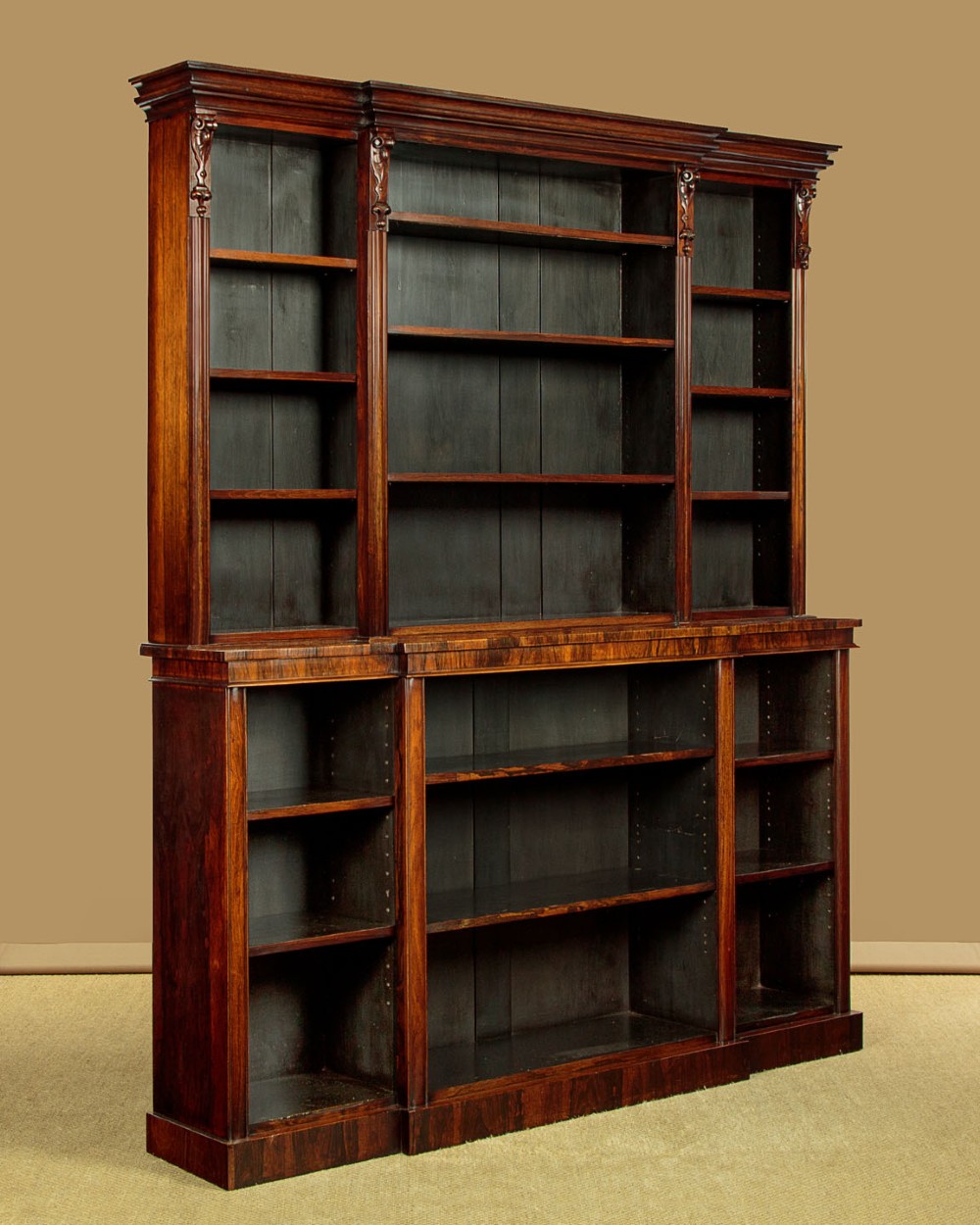 A mid-19th century dark rosewood open breakfront bookcase featuring a central projecting section flanked by narrower side shelves. View III