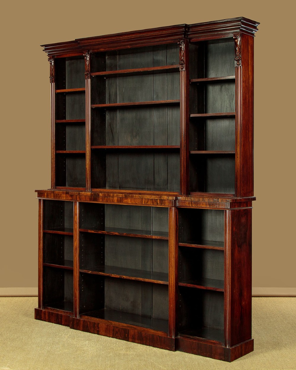 A mid-19th century dark rosewood open breakfront bookcase featuring a central projecting section flanked by narrower side shelves. View IV
