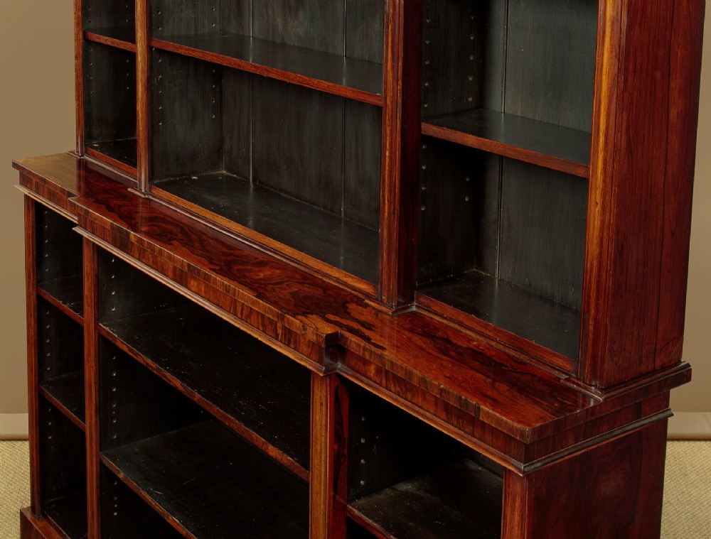 A mid-19th century dark rosewood open breakfront bookcase featuring a central projecting section flanked by narrower side shelves. View VII