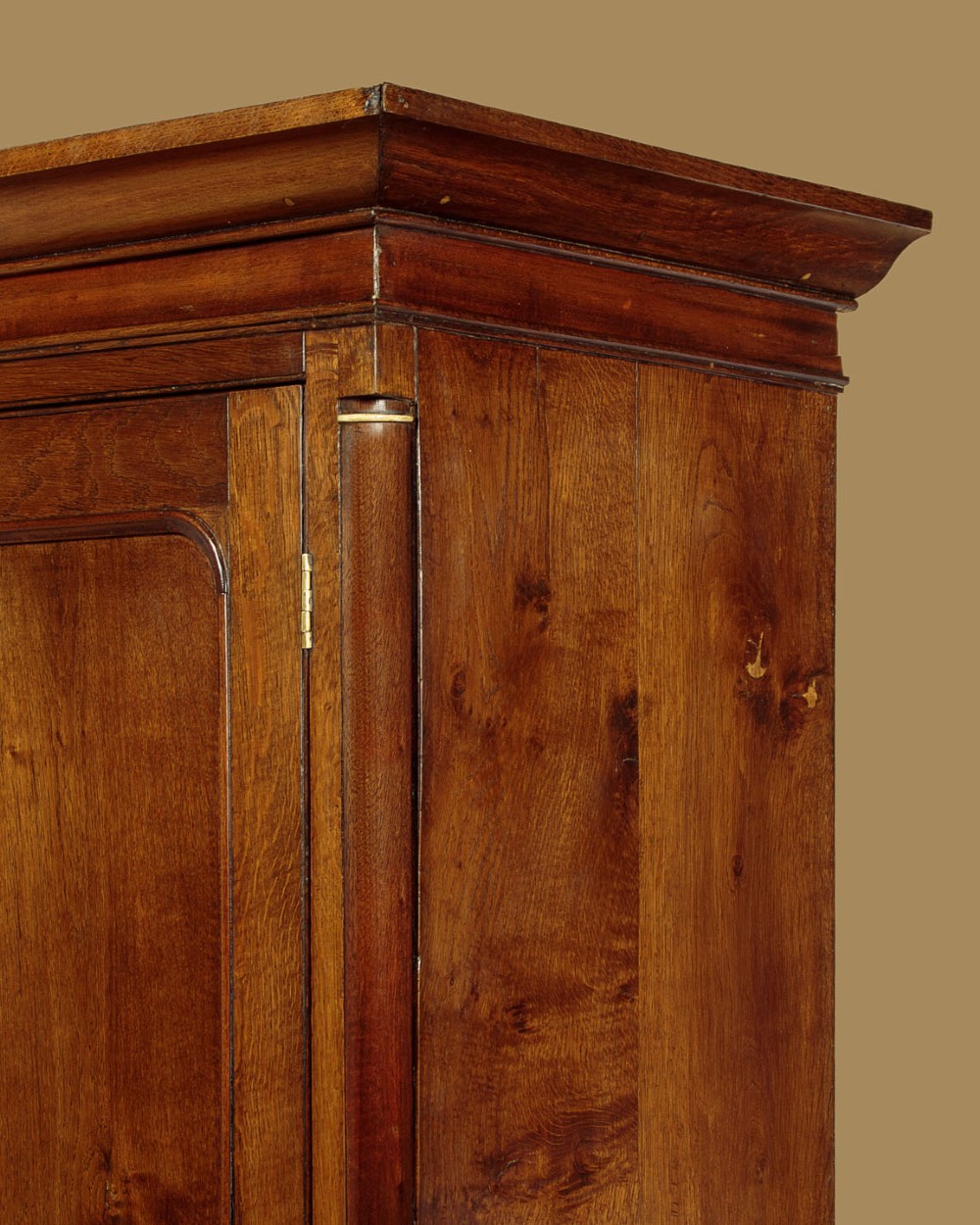 A Georgian Welsh oak press cupboard featuring a two-door upper section with fielded panels above a chest with five drawers and brass handles. View VII