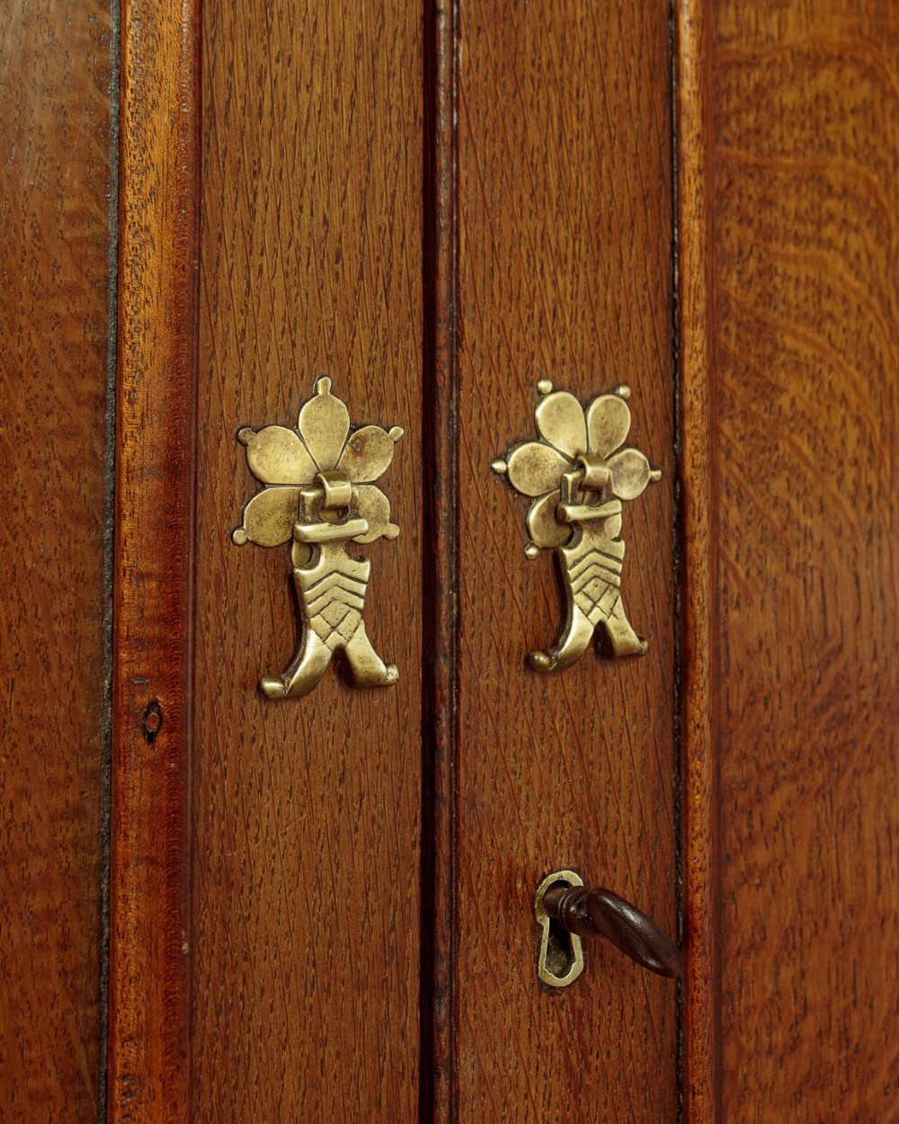 A Georgian Welsh oak press cupboard featuring a two-door upper section with fielded panels above a chest with five drawers and brass handles. View VIII