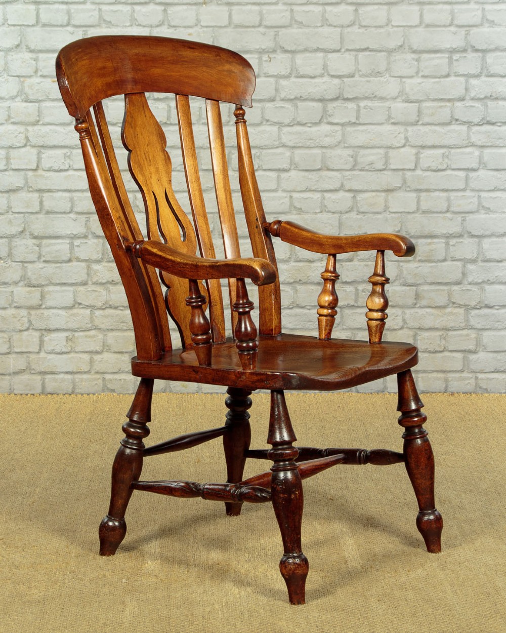 A Victorian highback wooden armchair featuring turned legs, curved armrests, a contoured seat, and a pierced back splat. View III